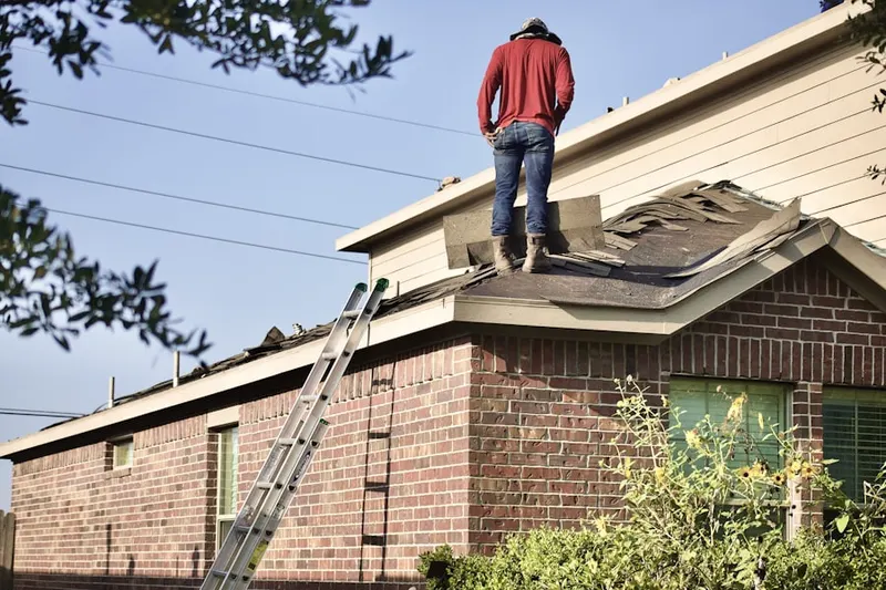 Professional roofer working on a residential roof in Moravia